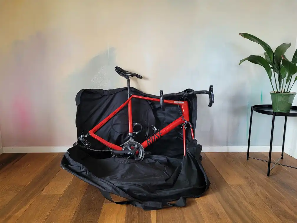 Both wheels in the bag and bicycle on top