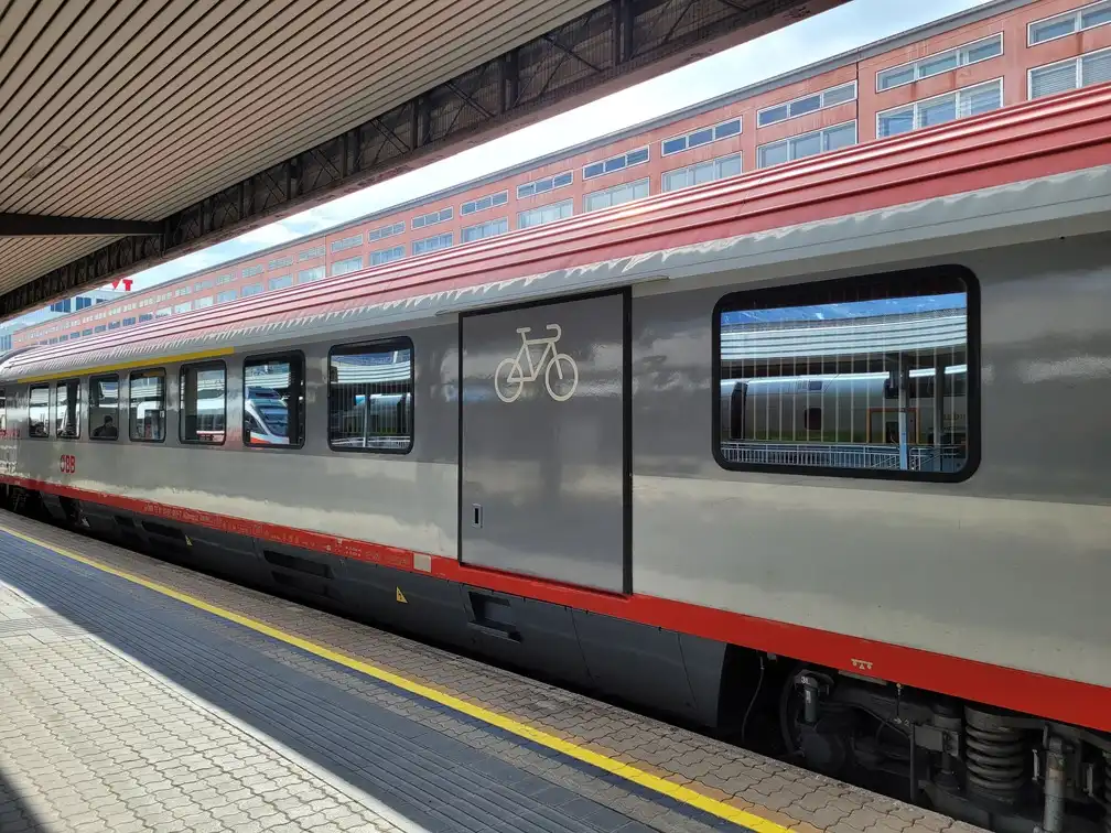 Traditional carriage on a platform with a large bicycle room