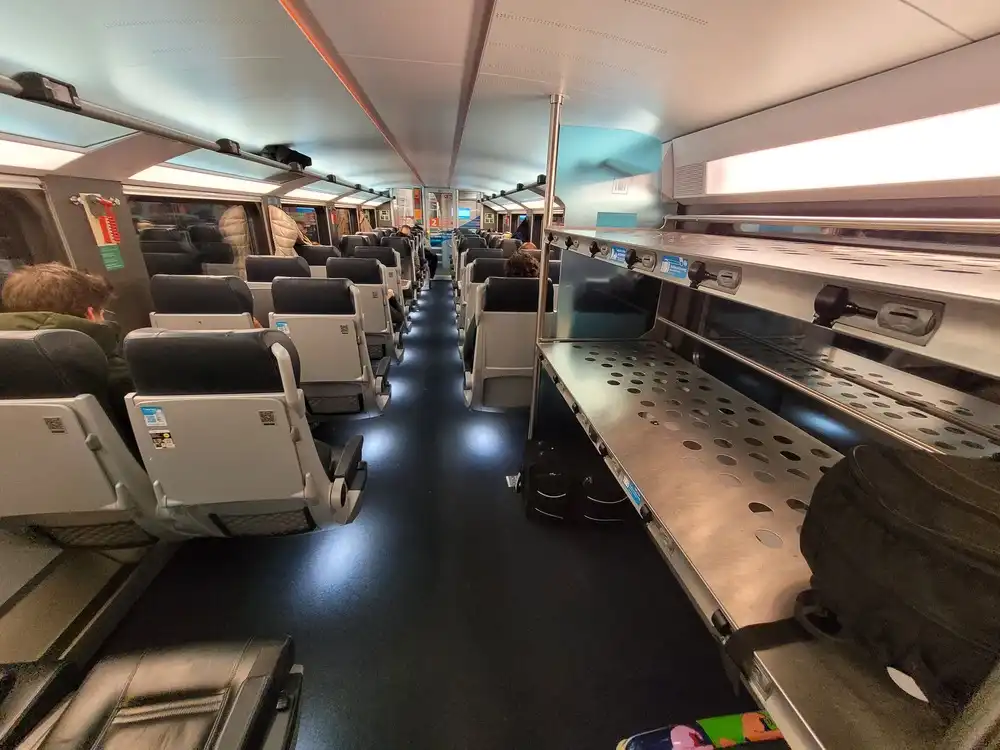 Luggage racks and seats downstairs in a WESTBahn train