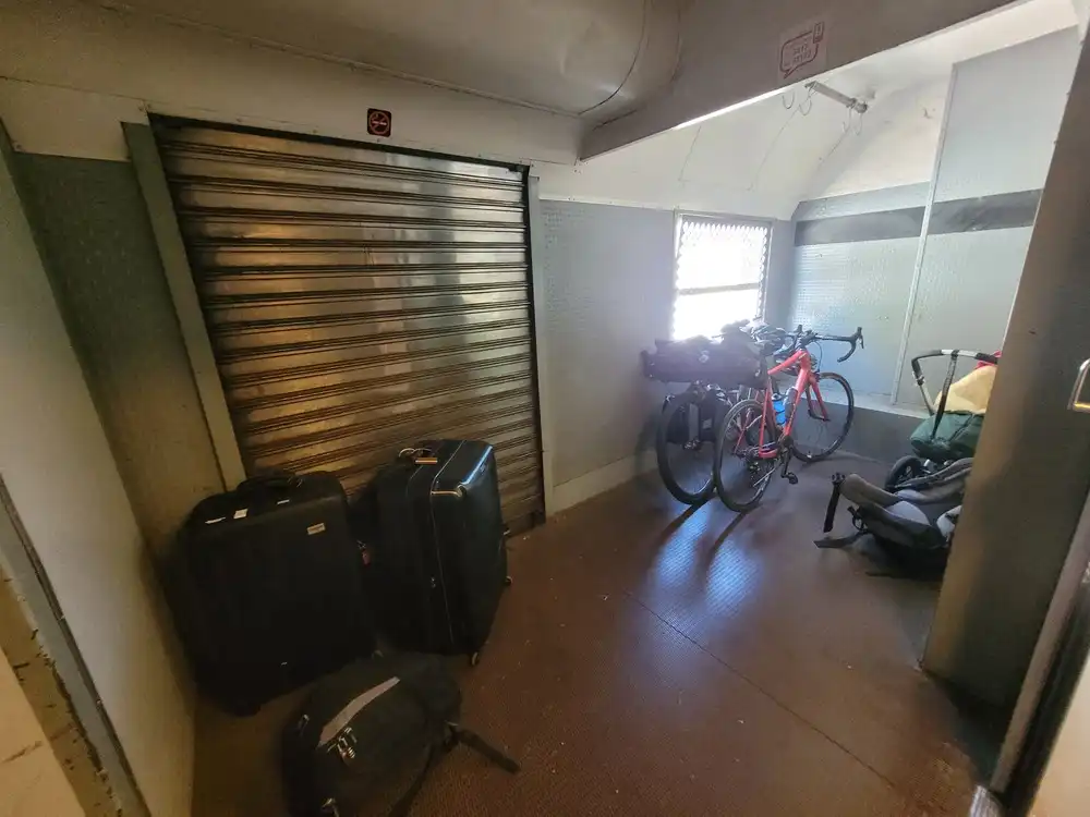 Cargo room with bicycles and various pieces of luggage