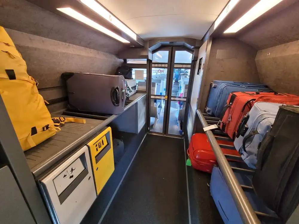 Half-full long luggage racks on both sides of the corridor
