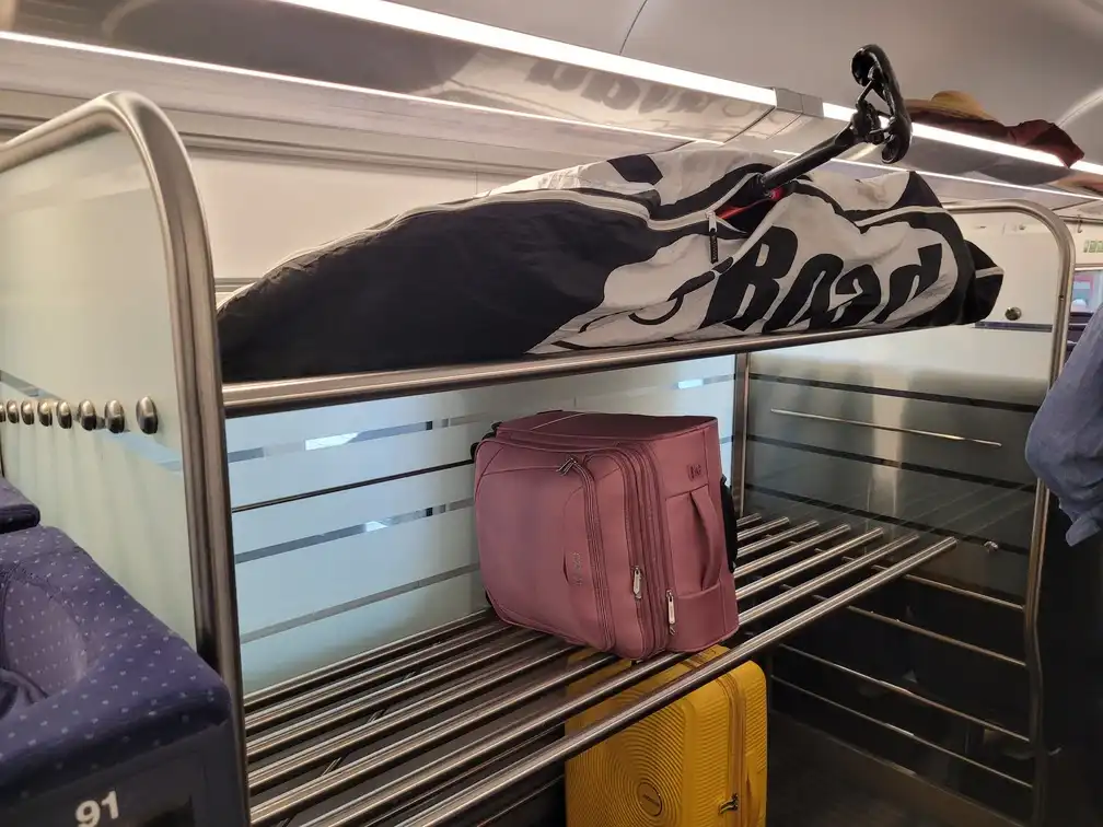 Packed bicycle on a luggage rack in an ICE 4 train