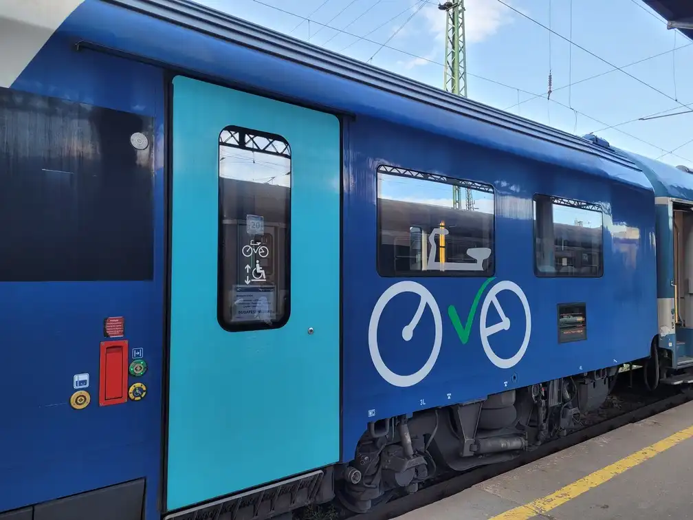 Train carriage with a large bicycle logo on a platform