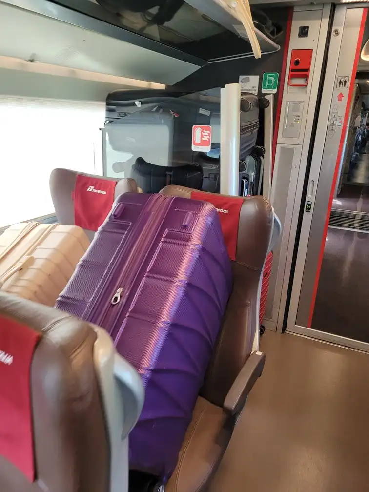 Extra luggage put on seats in an ETR 1000 train