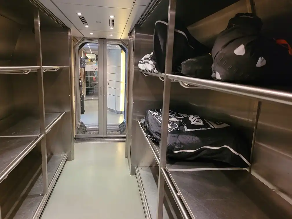 Shelves behind the restaurant where many packed bicycles fit in a Renfe series 103