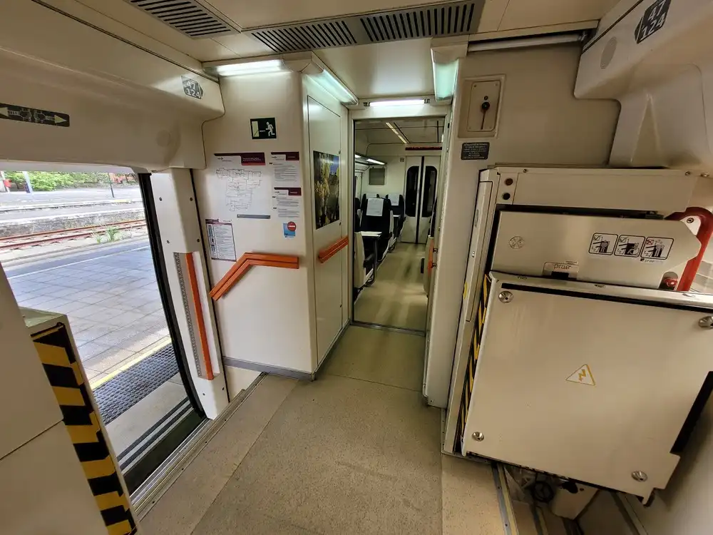 Entrance area with accessibility lifts inside a Renfe series 594