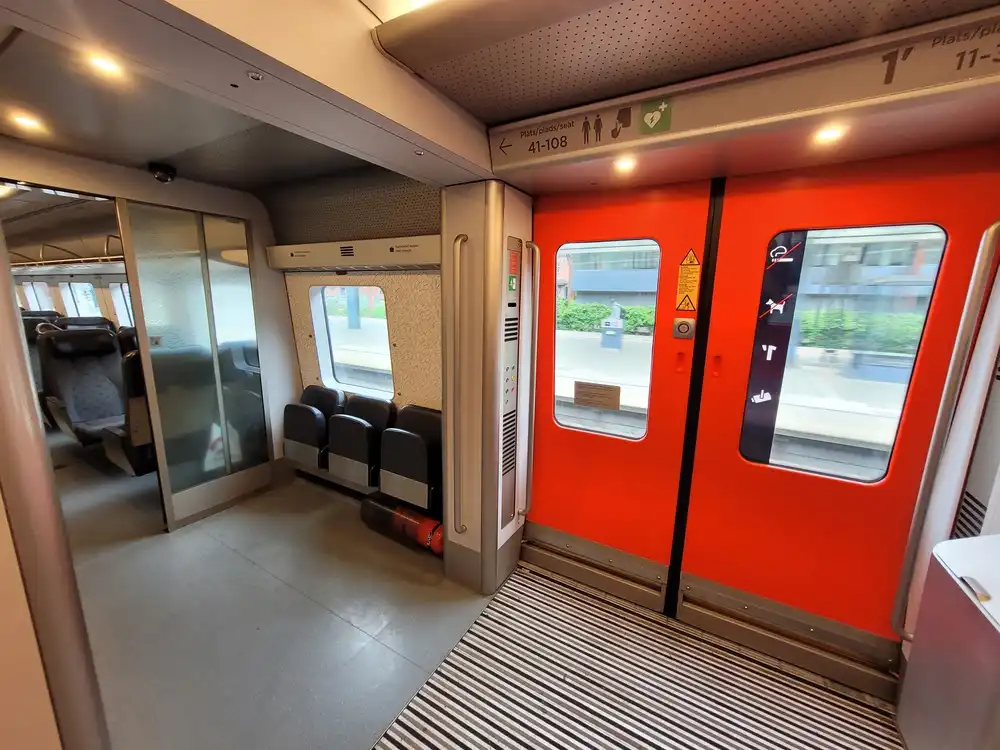 Regular entrance area with 3 foldable seats in an Øresundståg train