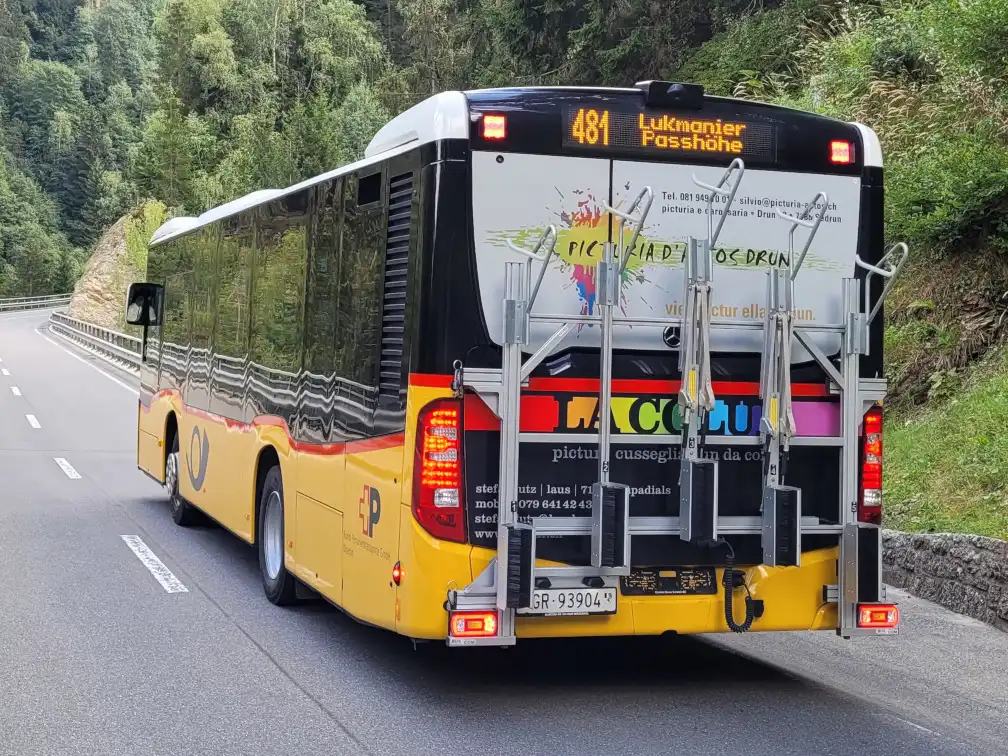 Bus with vertical bicycle racks outside at the back