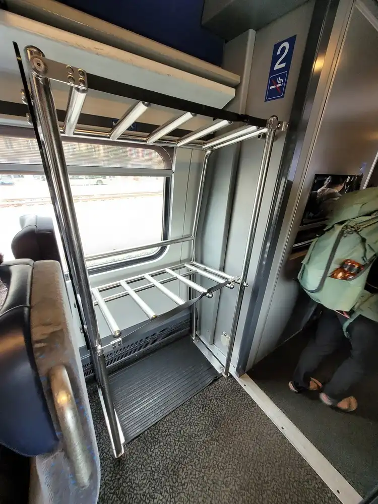 Additional luggage rack inside the tilting train, too narrow to fit a packed bicycle