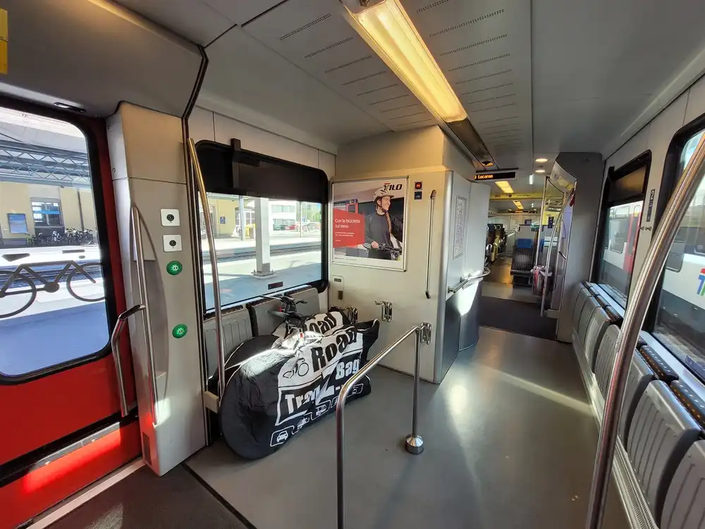 Train corridor with folded seats and two packed bicycles