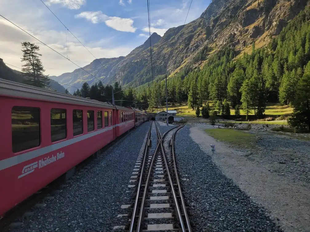 A red Swiss train in the mountains